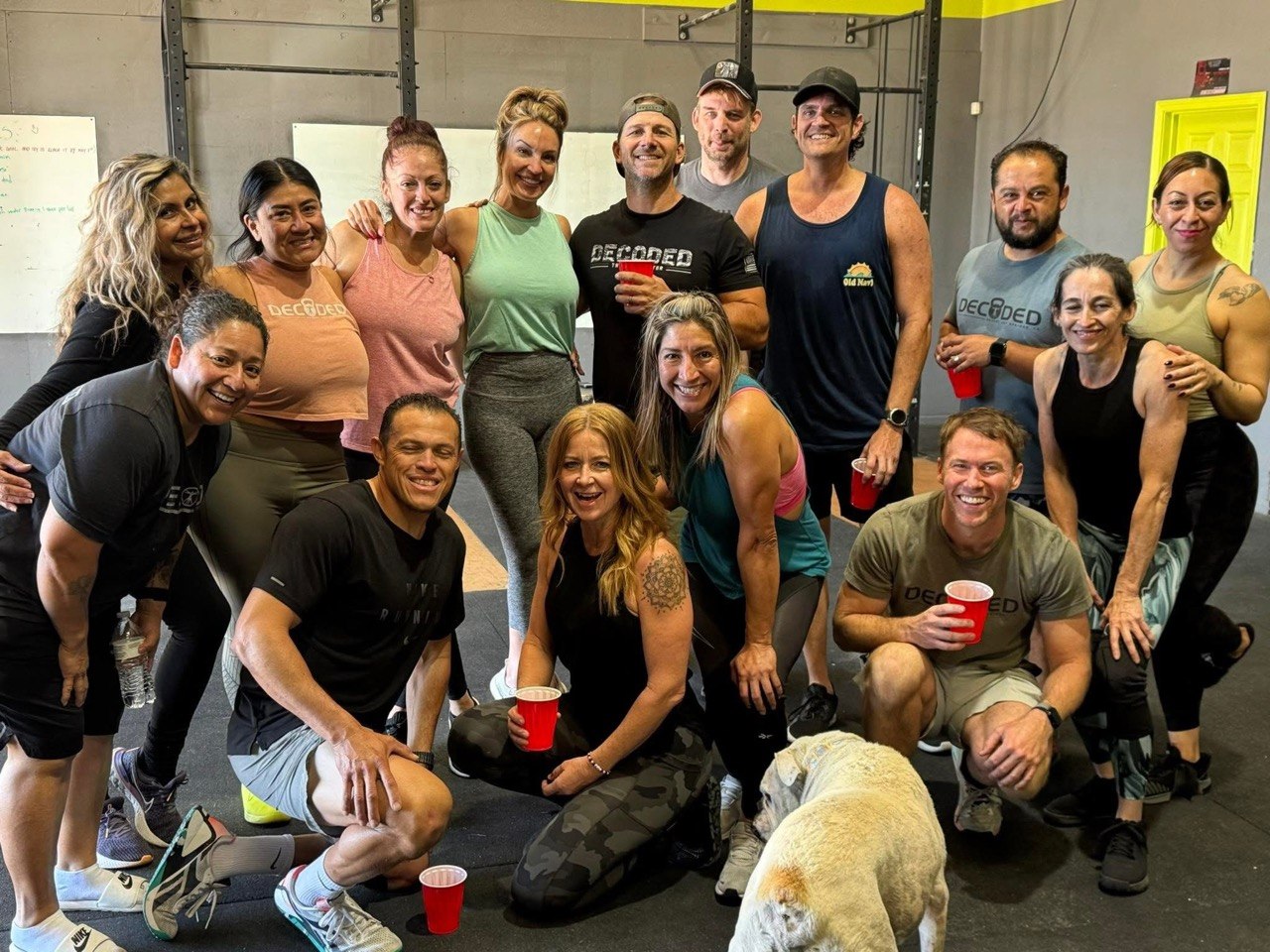 Warm after-class group photo with the gym bulldog up front