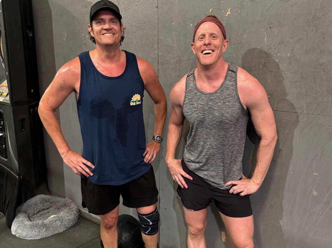 Two members posing together after a good workout
