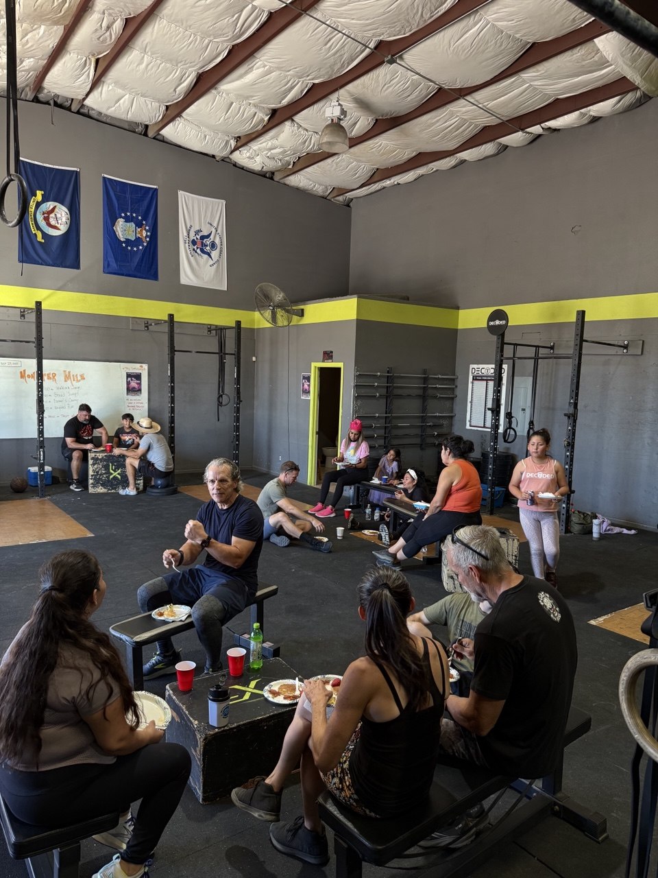 Members hanging out with pancakes at a post-workout breakfast