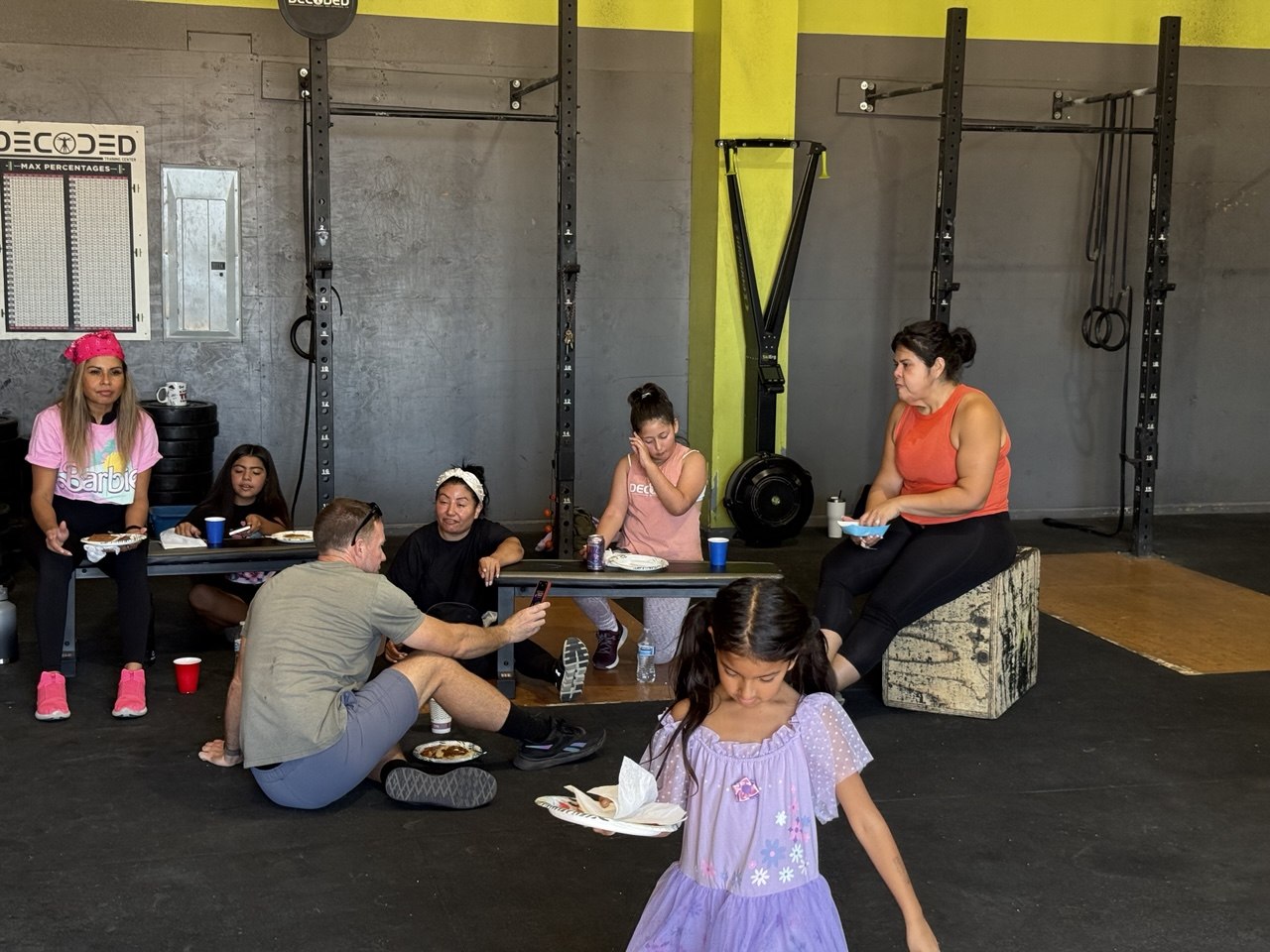 Family and members relaxing with food after class