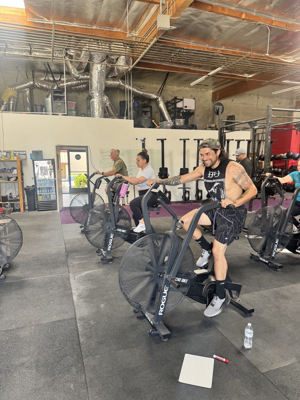 Member digging in on the air bike during class