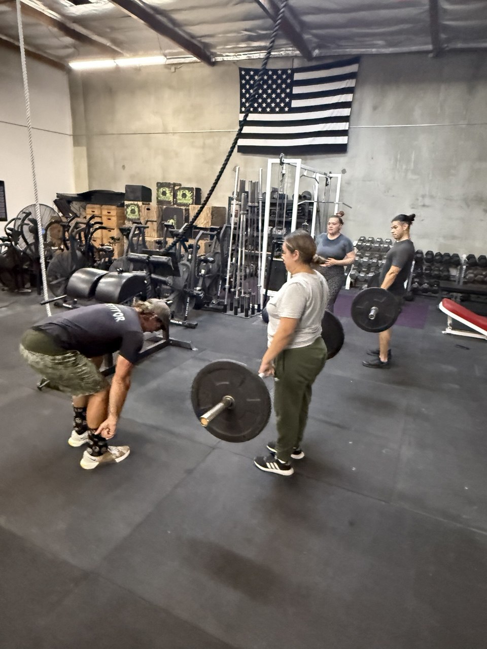 Members working the barbells during strength
