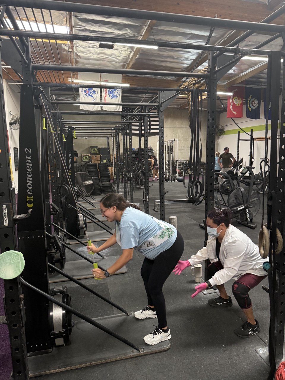 Members wiping down the rowers after class