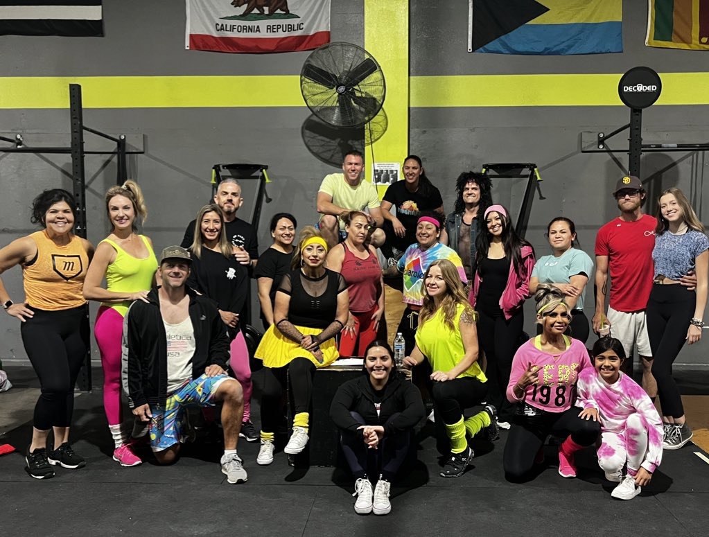 First Friday 80's Night big group photo in neon costumes