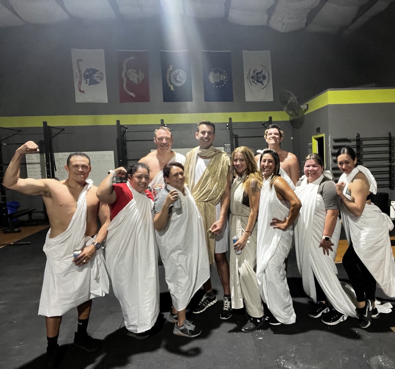 First Friday Toga Party group in togas flexing