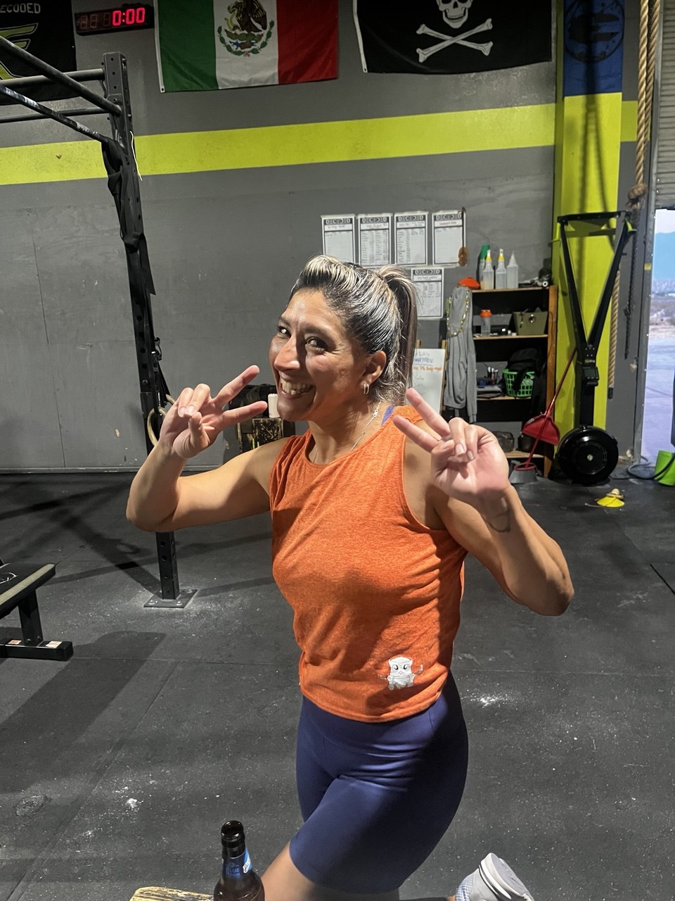 First Friday member throwing double peace signs
