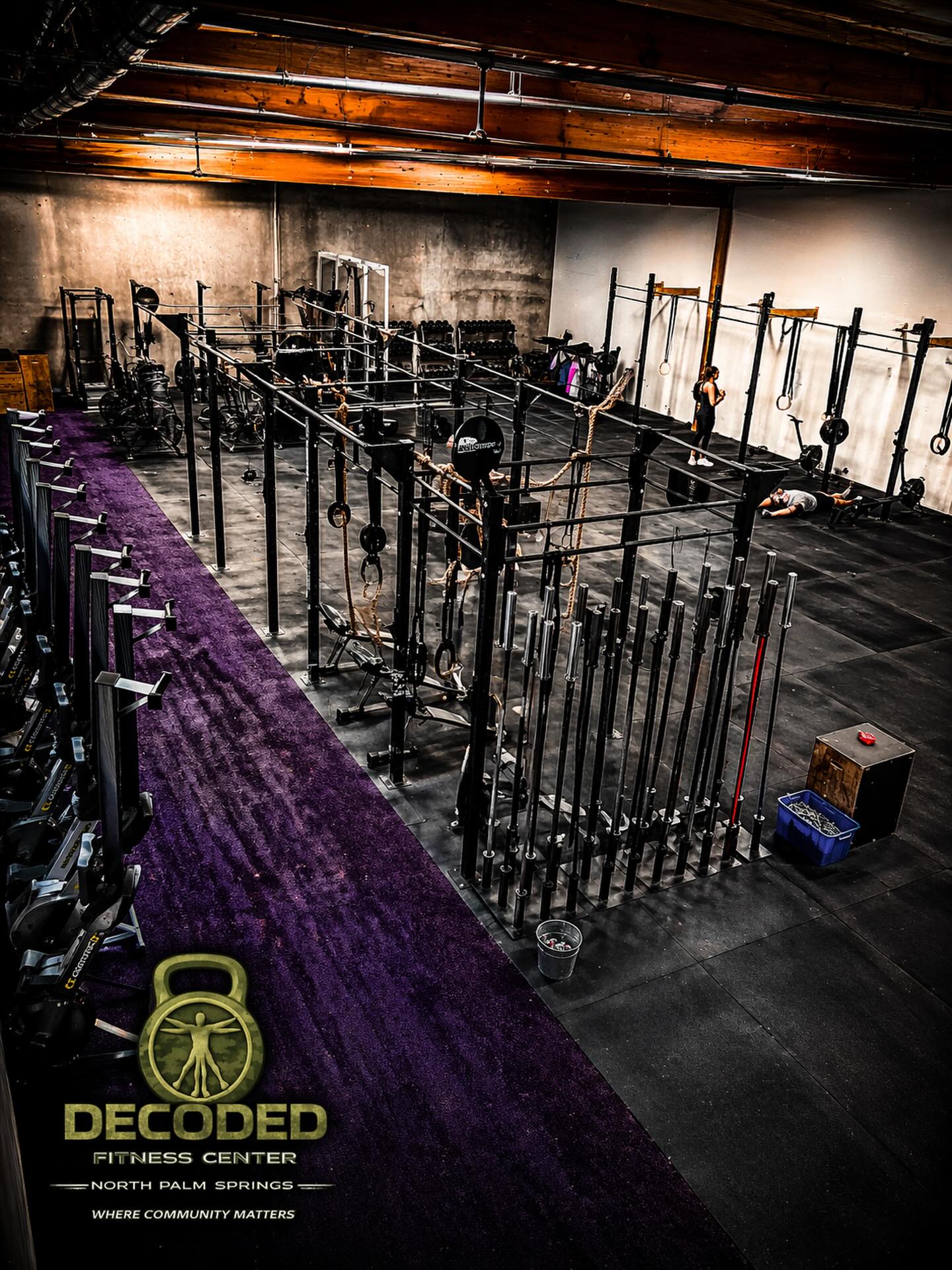 Decoded Fitness Center gym floor with rigs and barbells
